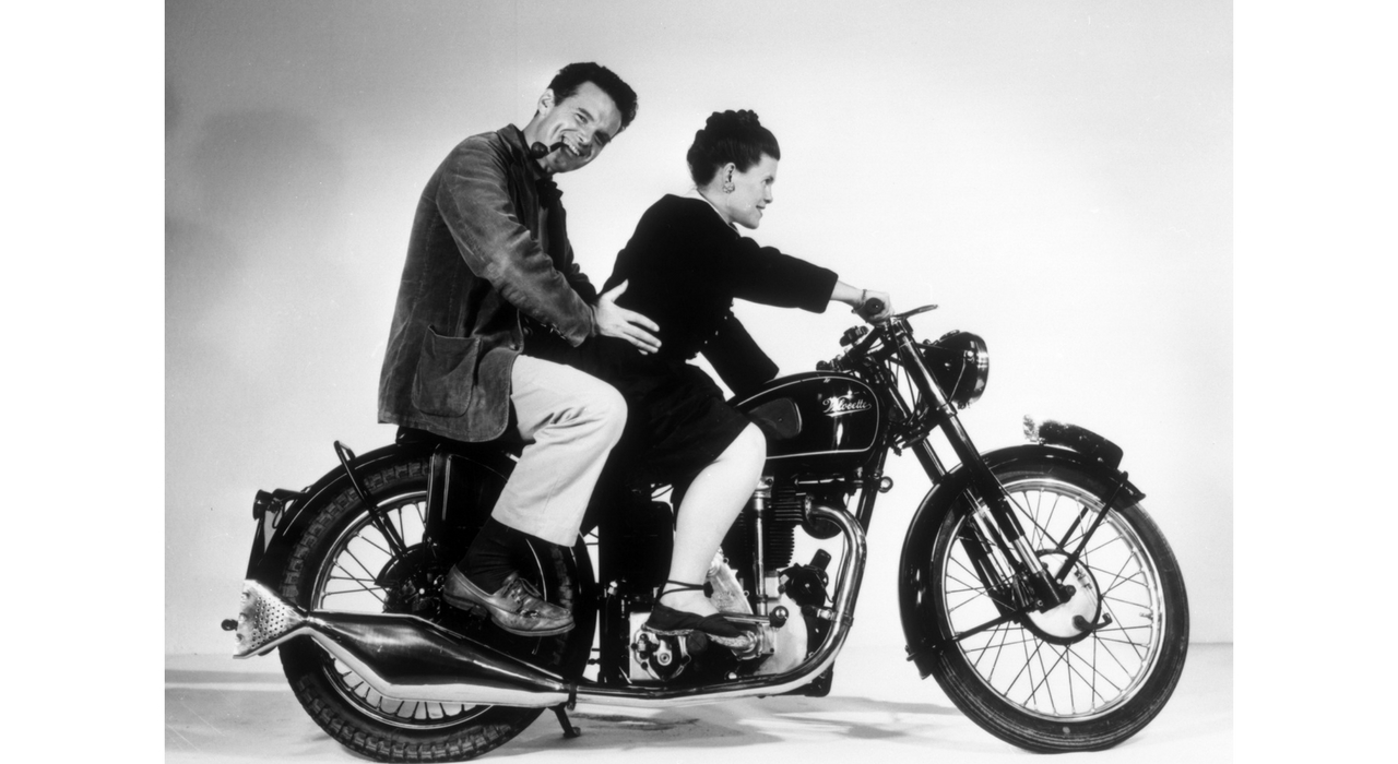 An Eames Celebration. Charles and Ray Eames posing on a Velocette Motorcycle, 1946. ©Eames Office LLC